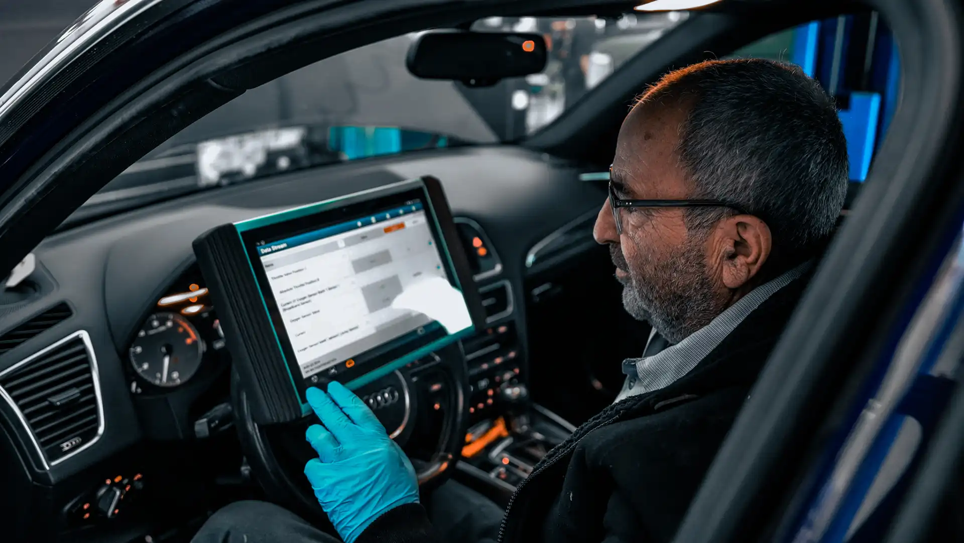 Technician diagnosing the car performance and engine